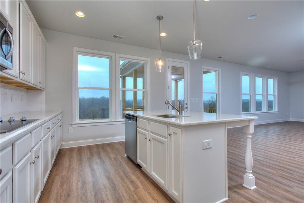 113 Swallowtail Lane Homer, GA 30547 - Photo 15 of 45 a bathroom with a vanity a sink a large mirror and a bathtub