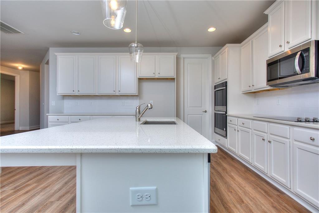 113 Swallowtail Lane Homer, GA 30547 - Photo 18 of 45 a kitchen with stainless steel appliances a sink cabinets and wooden floor