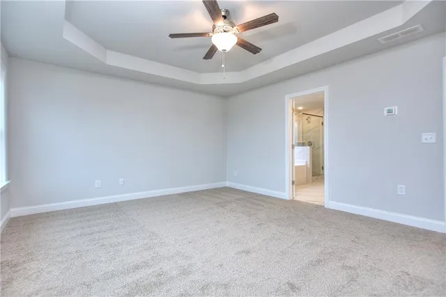 a view of an empty room and a ceiling fan