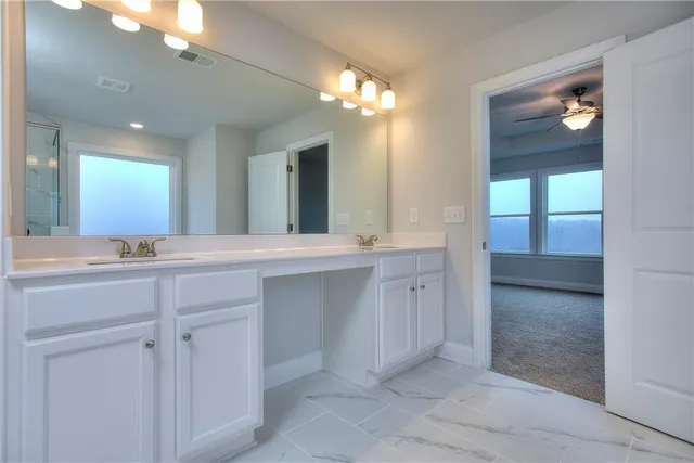 a bathroom with a double vanity sink and a mirror