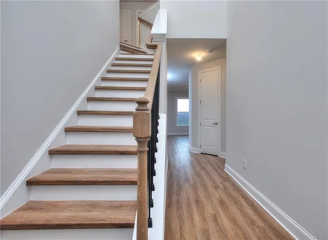 a view of an entryway with wooden floor