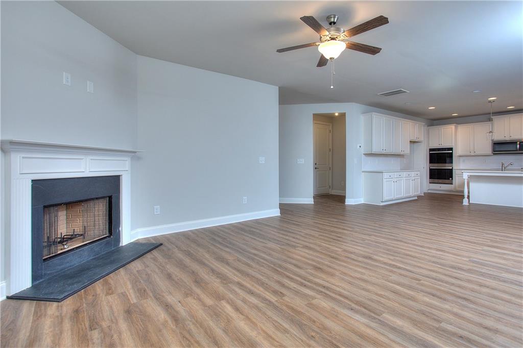 113 Swallowtail Lane Homer, GA 30547 - Photo 8 of 45 a view of an empty room with a kitchen and a fireplace