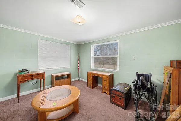 a room with furniture a flat screen computer and a lamp