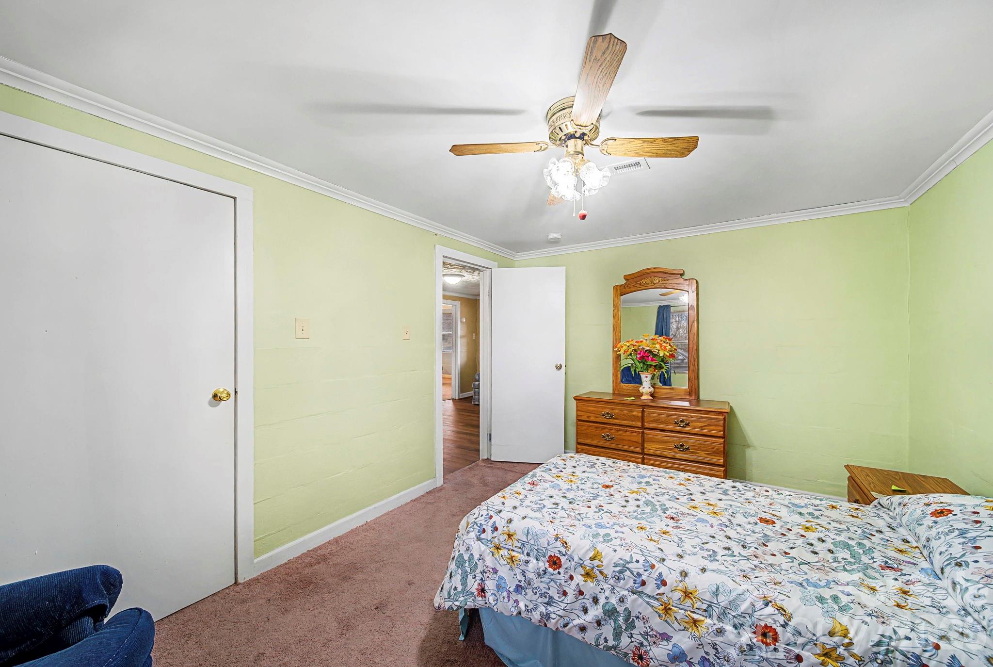 14309 Liberty Hill Church Road Oakboro, NC 28129 - Photo 21 of 37 a bedroom with a bed and dresser
