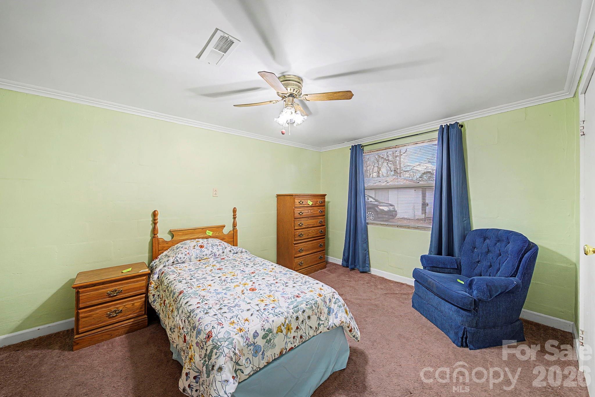 14309 Liberty Hill Church Road Oakboro, NC 28129 - Photo 23 of 37 a bedroom with a bed couch and a window