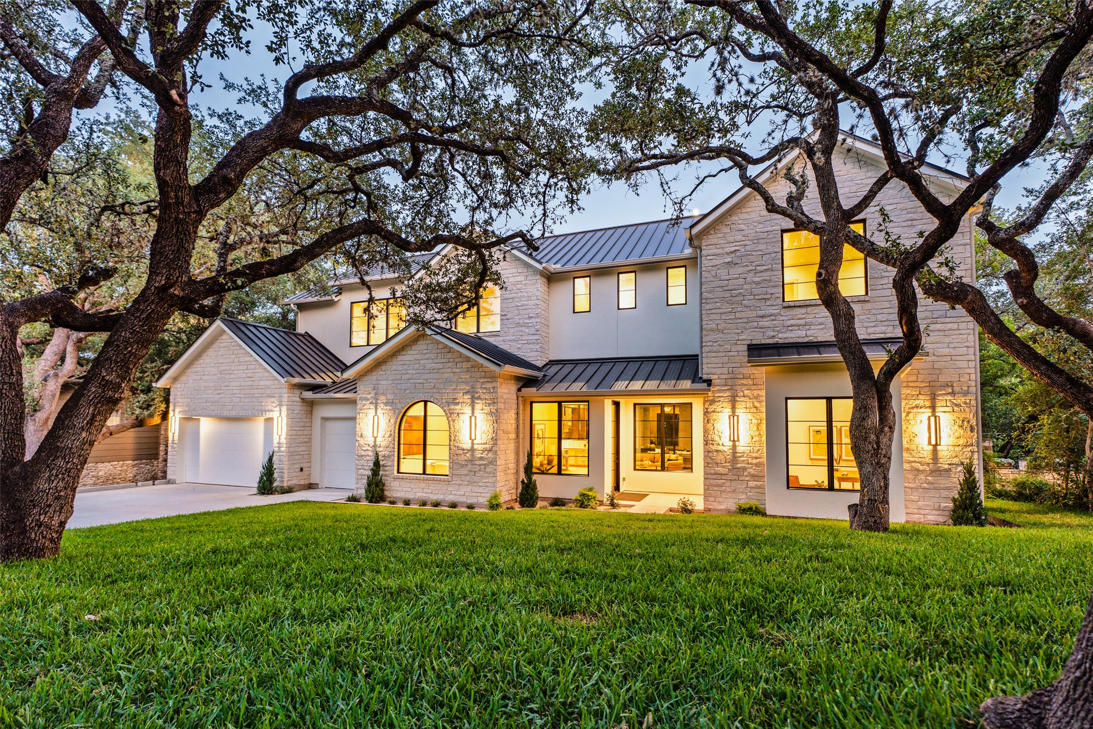 411 Honeycomb Ridge Austin, TX 78746 - Photo 1 of 1 View of front facade featuring a standing seam roof, a metal roof, and driveway