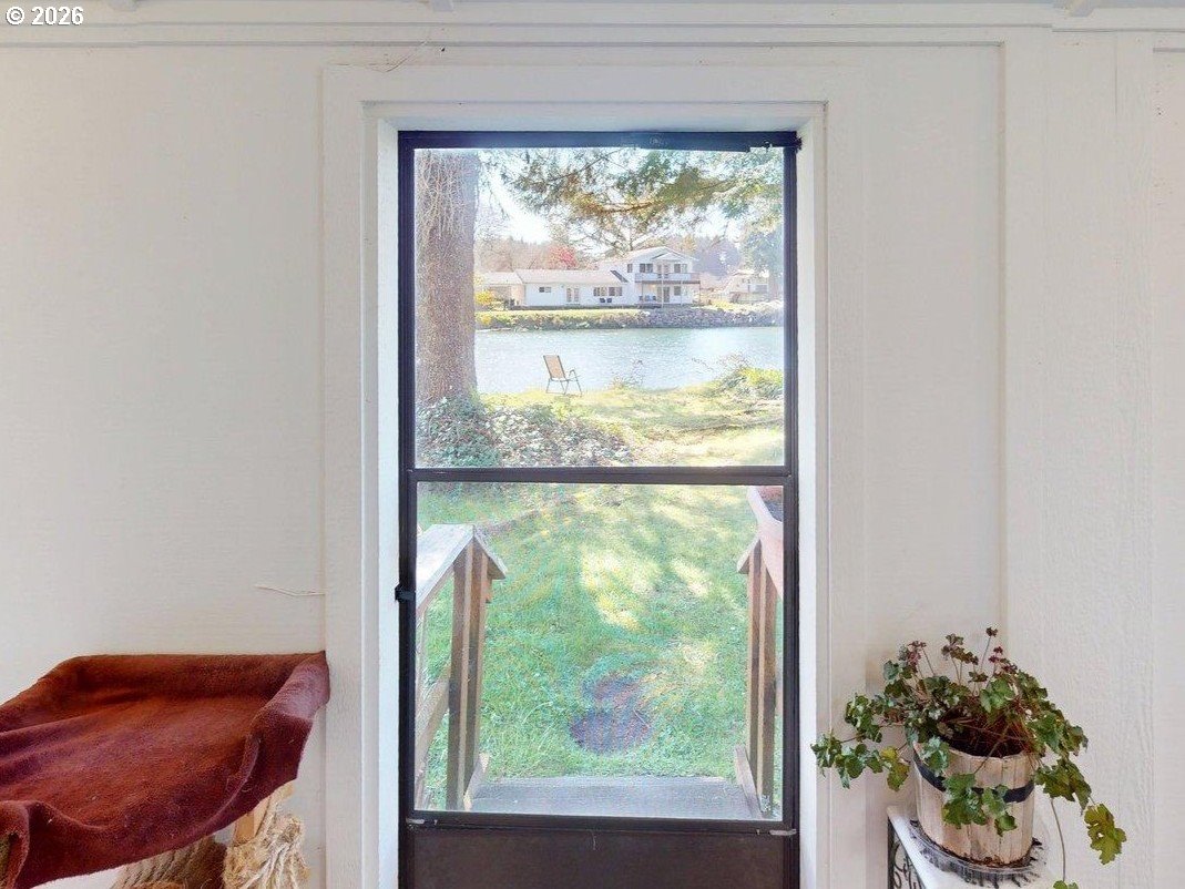 99270 Winchuck River Road Brookings, OR 97415 - Photo 13 of 40 a room with a large window and a bed