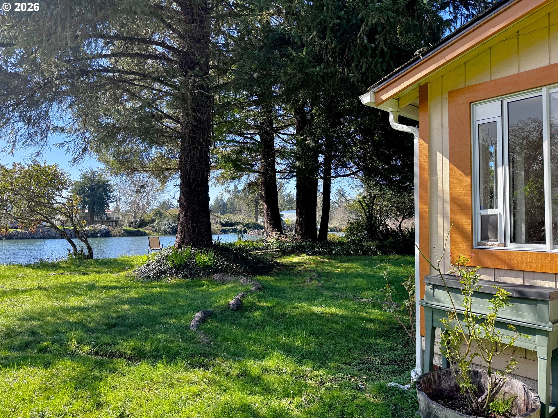 99270 Winchuck River Road Brookings, OR 97415 - Photo 2 of 40 a view of a backyard with plants and large trees