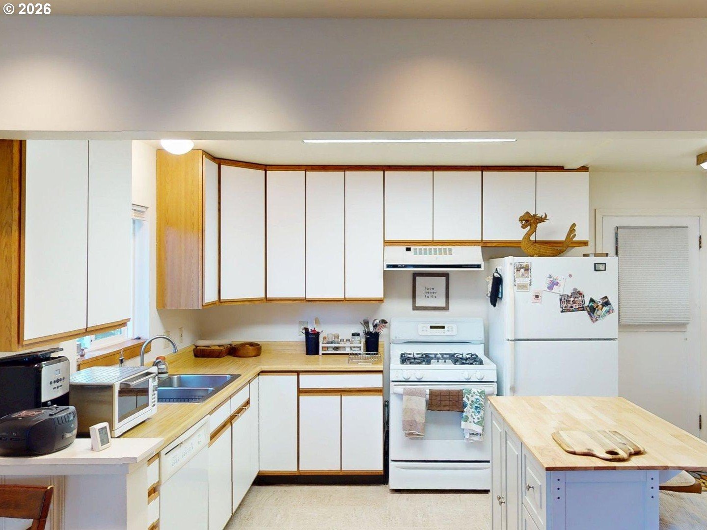 99270 Winchuck River Road Brookings, OR 97415 - Photo 21 of 40 a kitchen with a stove a sink and a refrigerator