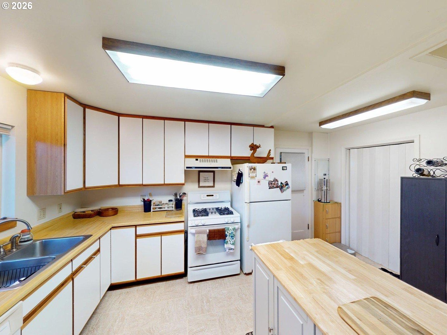 99270 Winchuck River Road Brookings, OR 97415 - Photo 24 of 40 a kitchen with a refrigerator a stove a sink dishwasher and wooden cabinets