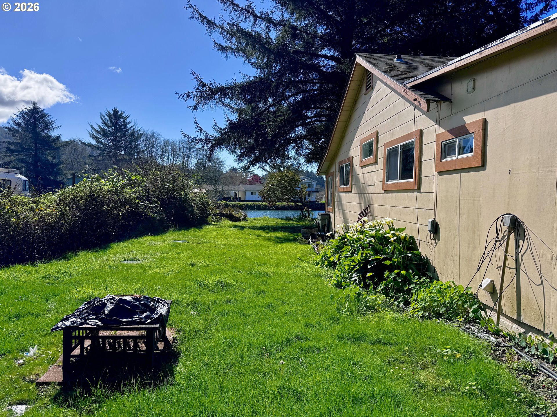 99270 Winchuck River Road Brookings, OR 97415 - Photo 36 of 40 a front view of a house with garden