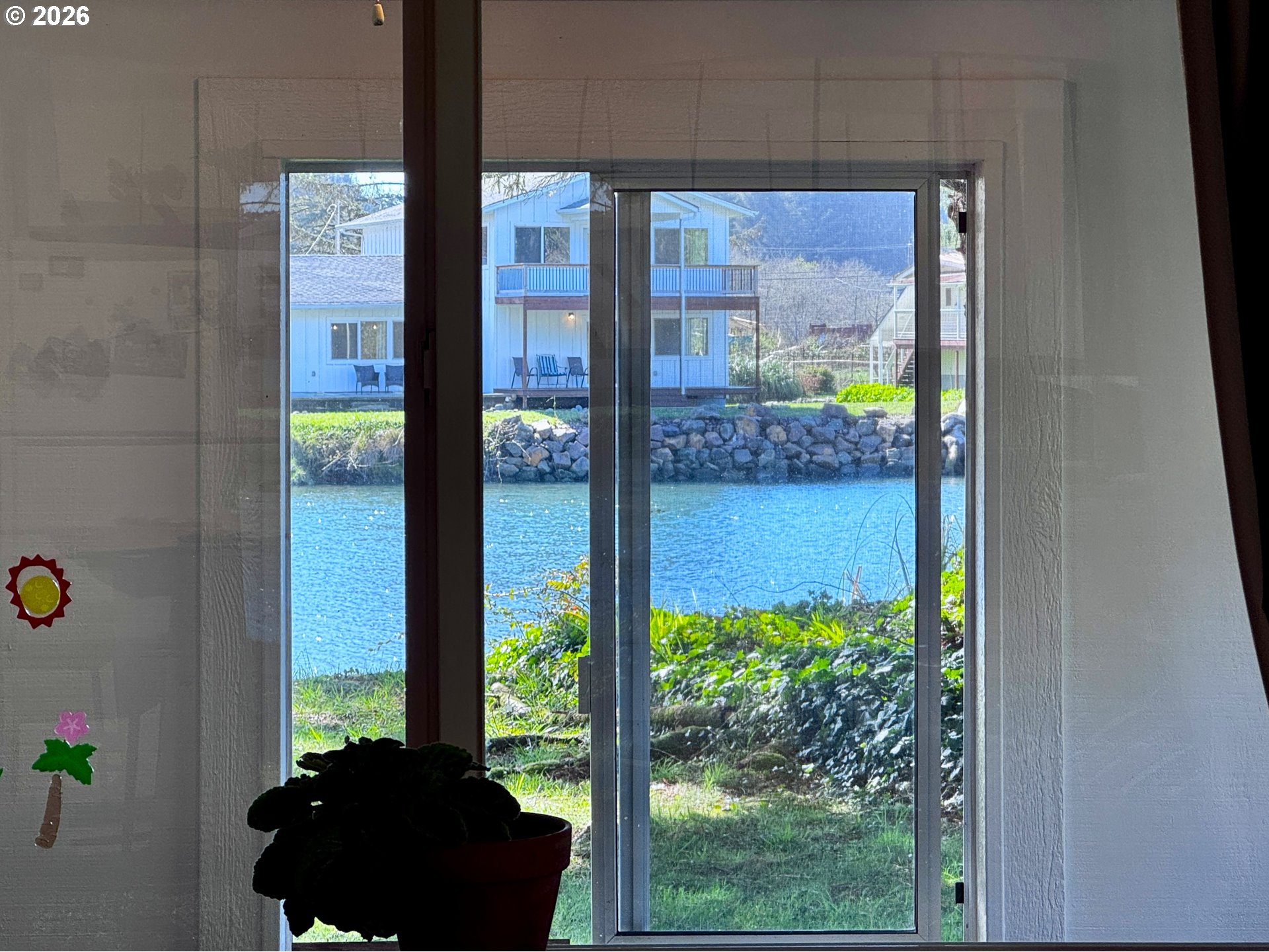 99270 Winchuck River Road Brookings, OR 97415 - Photo 10 of 40 a window and a potted plant in front of a door