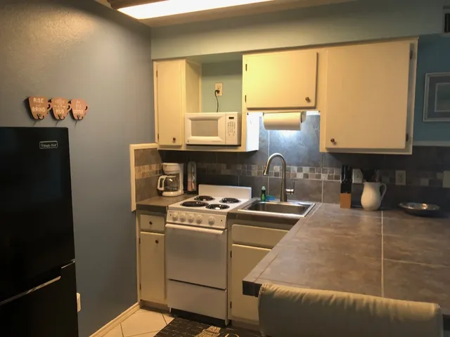 a kitchen with a stove and a microwave