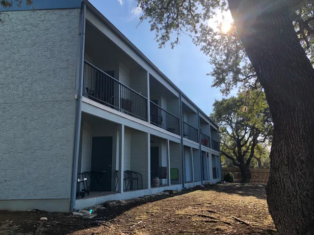 a view of a house with a tree in the background