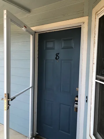 a bathroom with a glass door shower and closet
