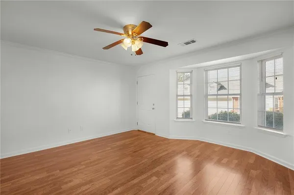 a view of a chandelier in big room and wooden floor