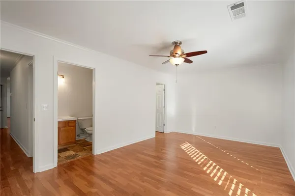 a view of an empty room with wooden floor
