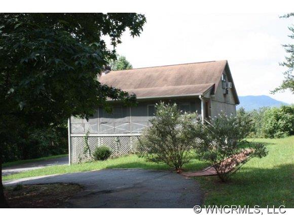 378 Hooker Road Tryon, NC 28782 - Photo 1 of 11 a view of a yard in front of a house with a garden