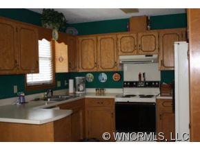 378 Hooker Road Tryon, NC 28782 - Photo 6 of 11 a kitchen with stainless steel appliances granite countertop a sink stove and cabinets