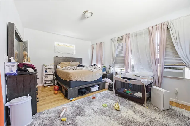 a bedroom with furniture and a wooden floor