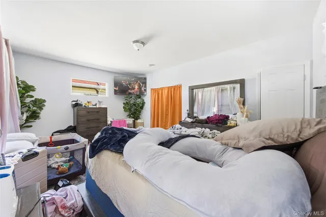 a bedroom with bed and a window