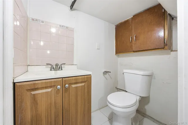 a bathroom with a sink a toilet and mirror