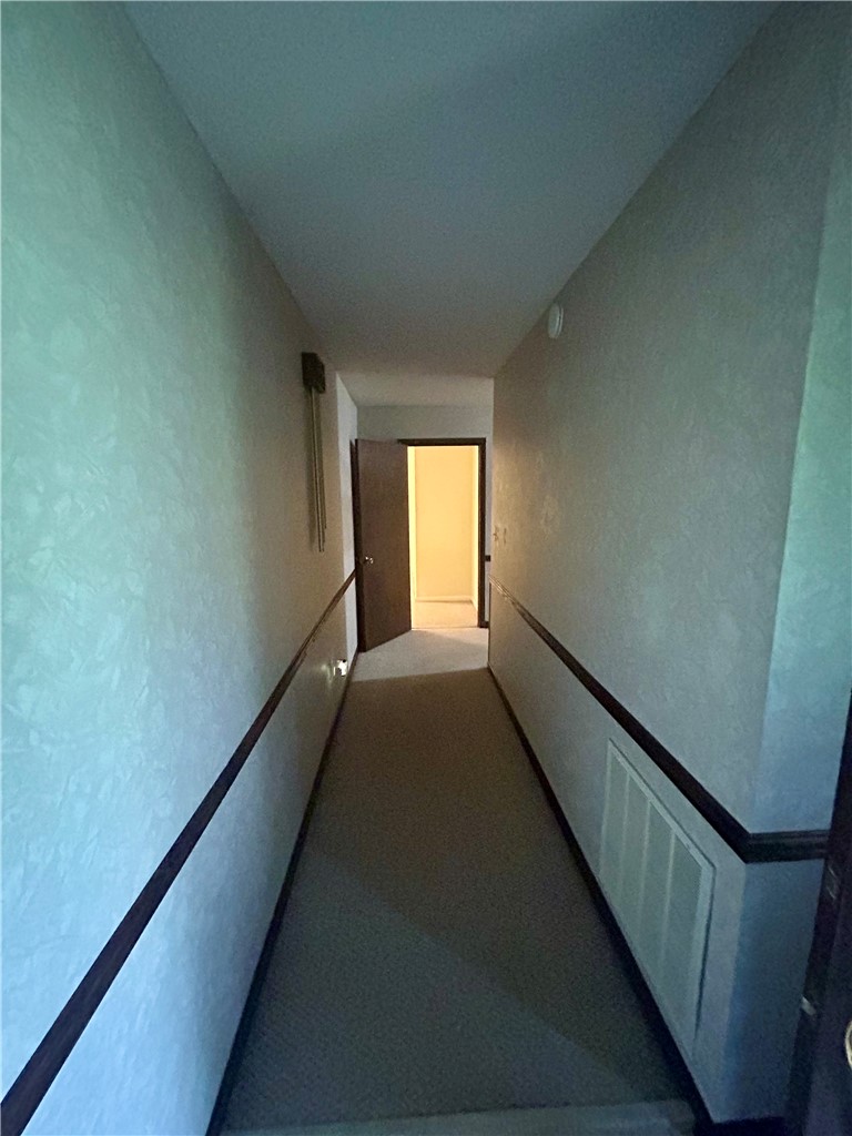 307 Mar-Mac Road Anderson, SC 29626 - Photo 10 of 19 A well-lit interior hallway offers a carpeted path leading to a sun-drenched room.