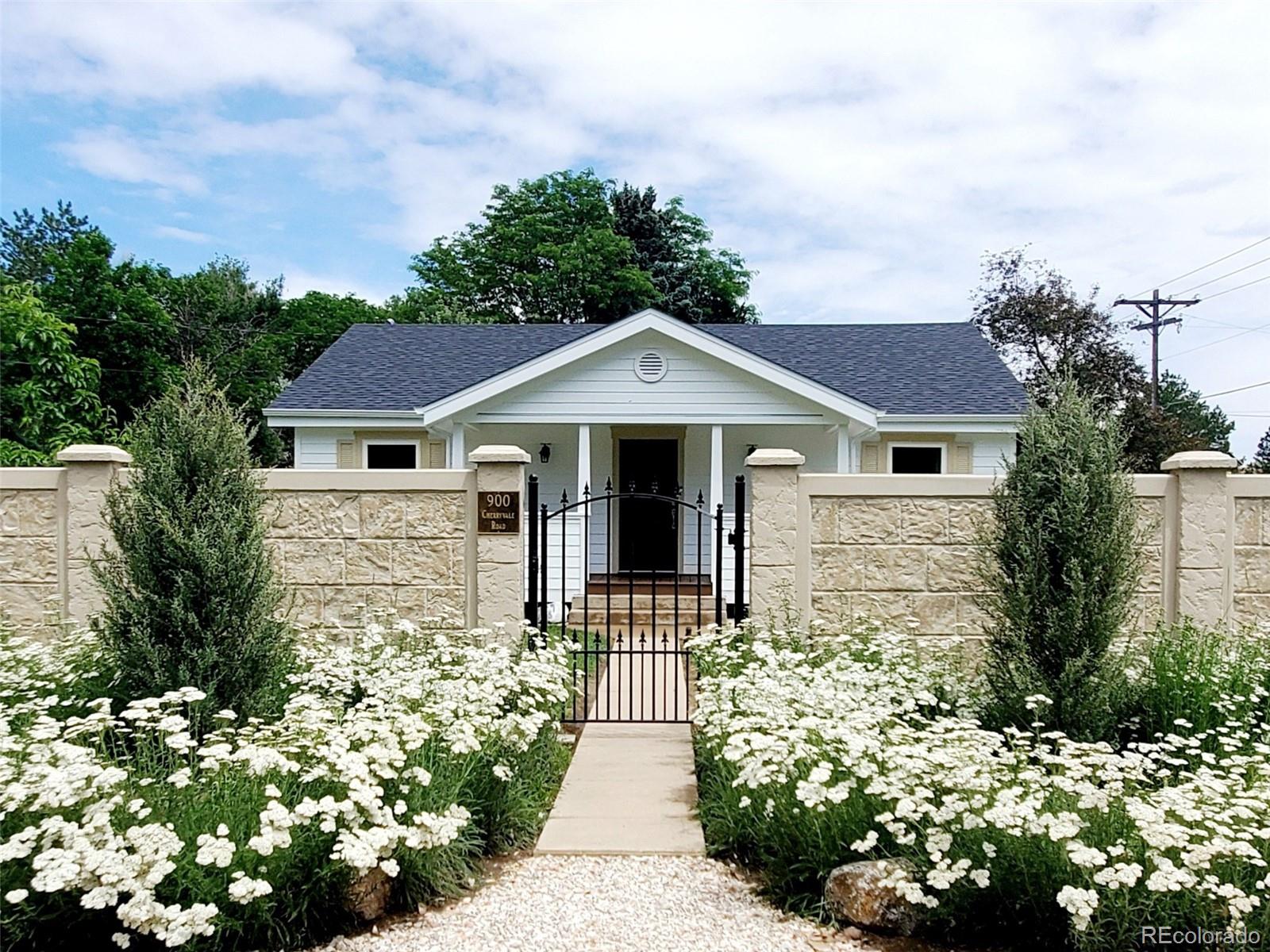 900 Cherryvale Road Boulder, CO 80303 - Photo 1 of 30 a front view of a house with a yard and potted plants