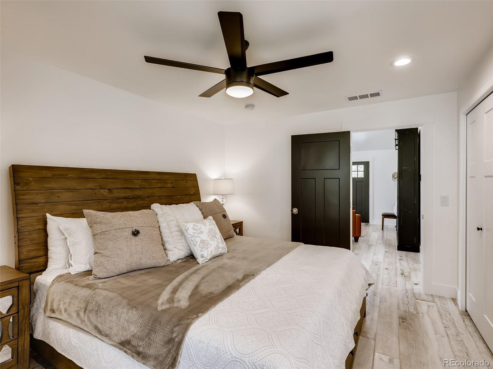 900 Cherryvale Road Boulder, CO 80303 - Photo 11 of 30 a bedroom with a large bed and ceiling fan