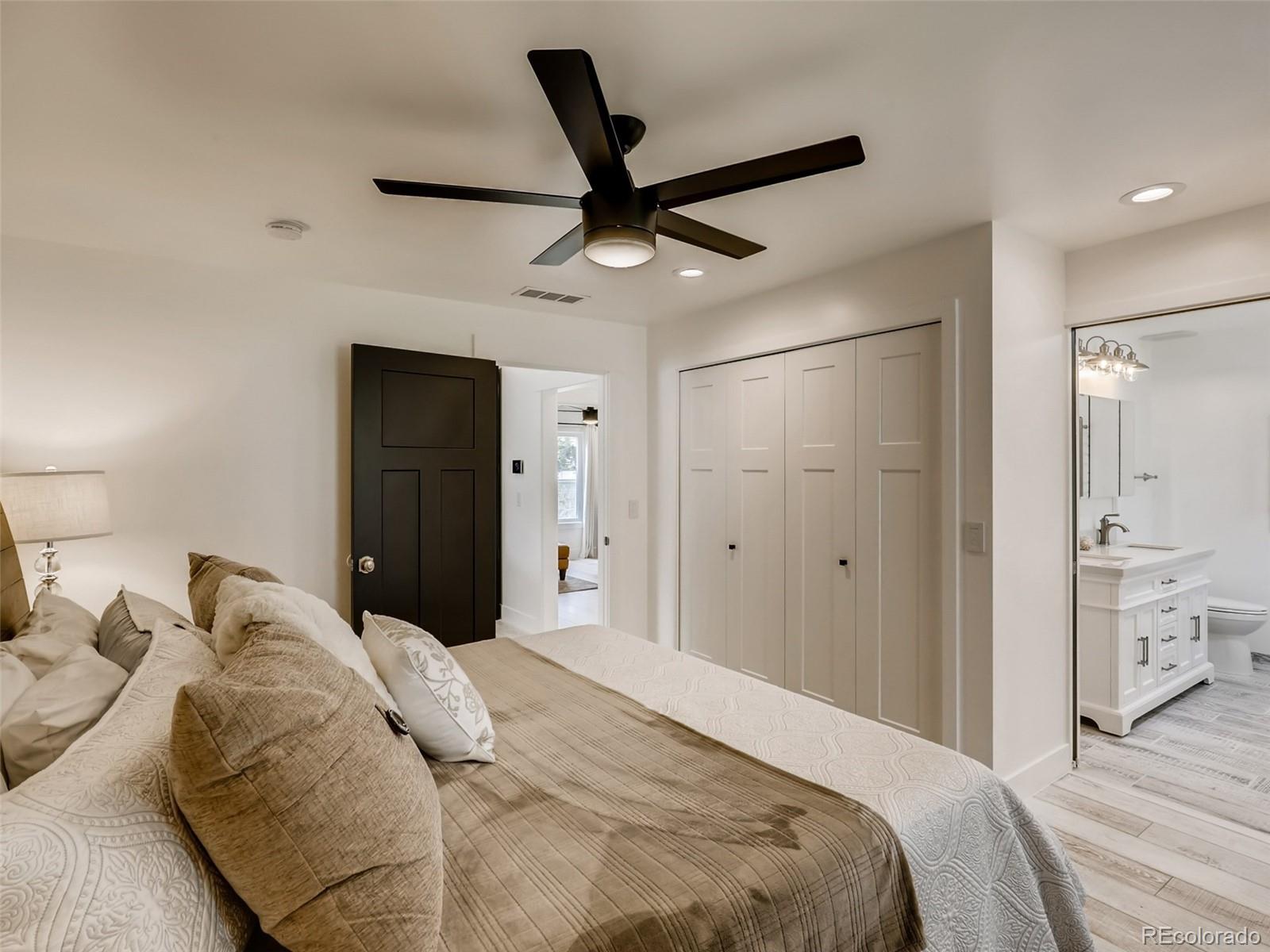 900 Cherryvale Road Boulder, CO 80303 - Photo 12 of 30 a bedroom with a large bed and a chandelier