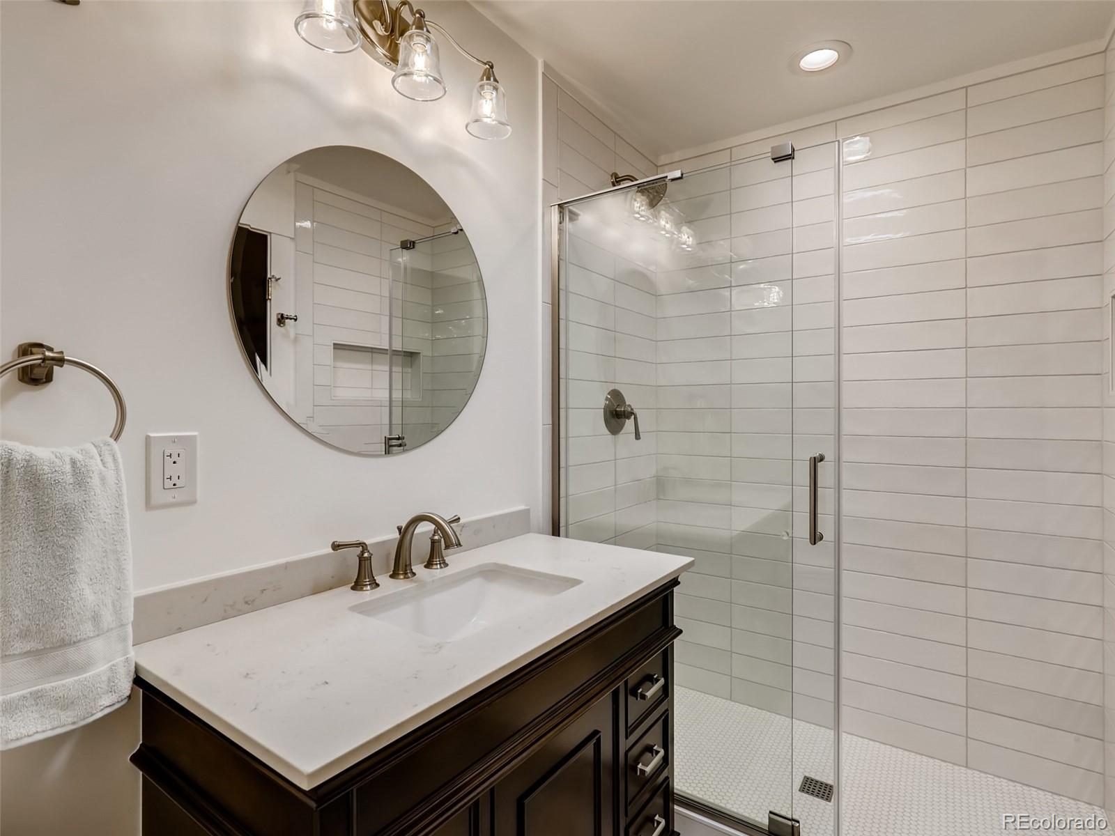 900 Cherryvale Road Boulder, CO 80303 - Photo 16 of 30 a bathroom with a sink a mirror a vanity and a shower