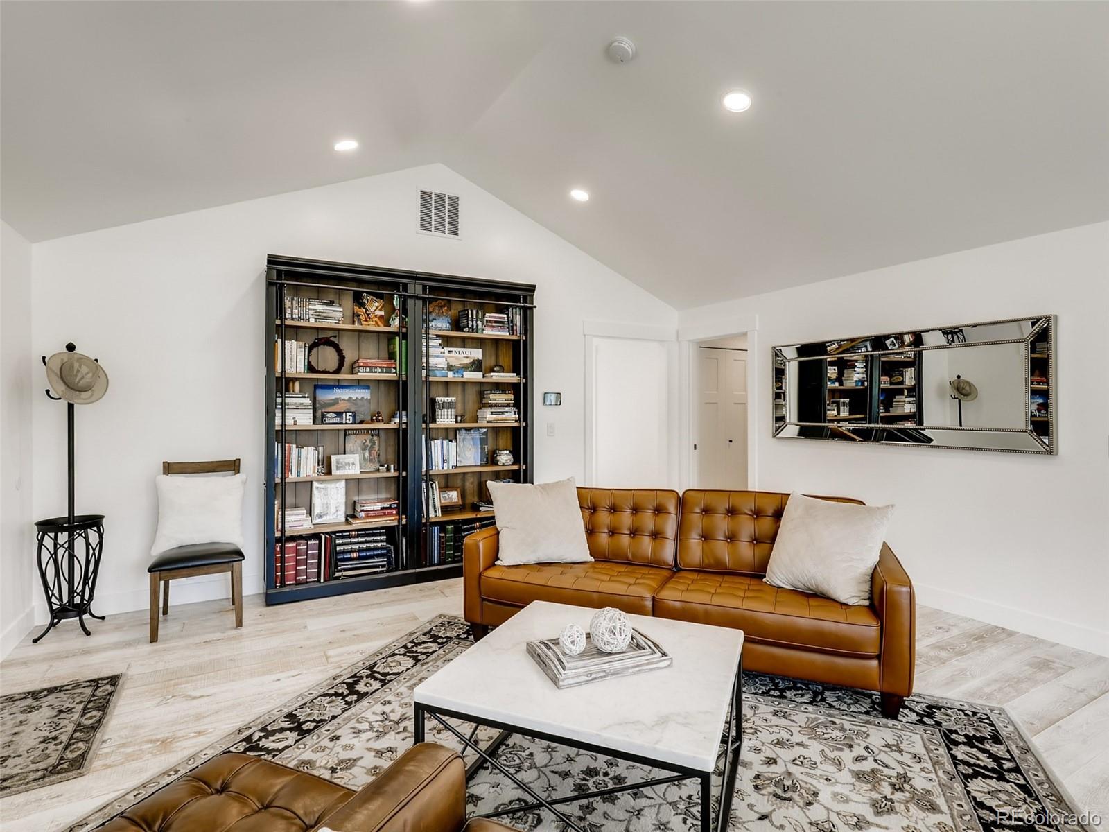 900 Cherryvale Road Boulder, CO 80303 - Photo 6 of 30 a living room with furniture and a book shelf