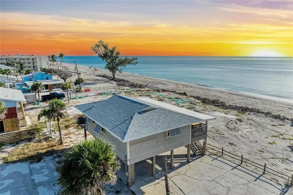 a view of a terrace with a table and chairs under an umbrella