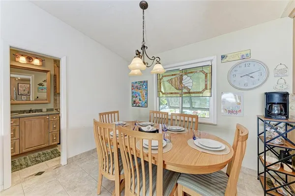a view of a dining room with furniture a rug and wooden floor