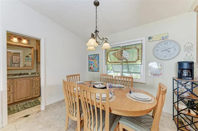 a view of a dining room with furniture a rug and wooden floor