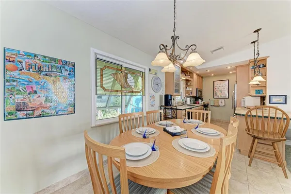 a view of a dining room with furniture a chandelier and wooden floor