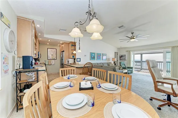 a kitchen with granite countertop a sink a stove and a refrigerator
