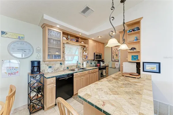 a kitchen with granite countertop a sink and cabinets