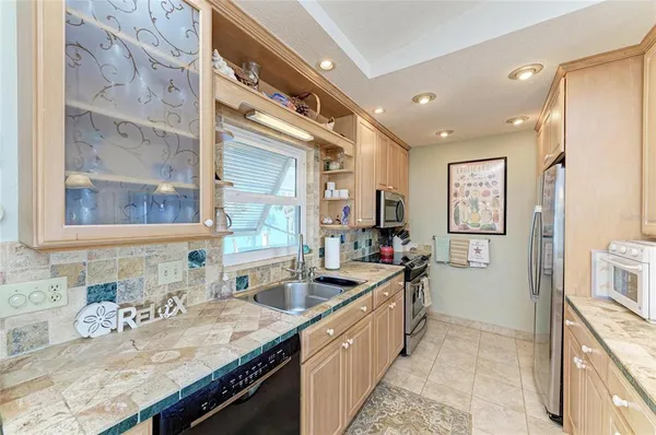 a kitchen with stainless steel appliances kitchen island granite countertop a sink and cabinets