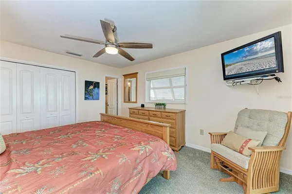 a bedroom with a large bed and a window