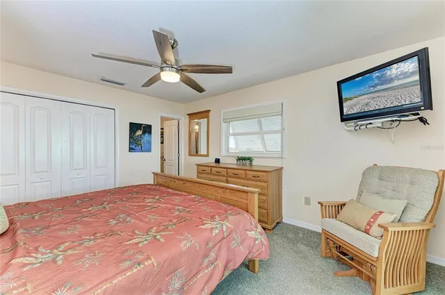 a bedroom with a large bed and a window