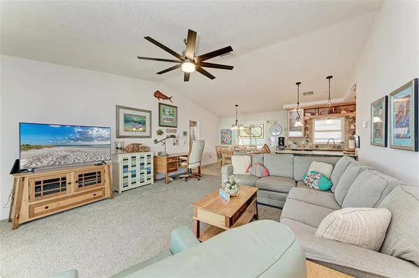a living room with furniture and a ceiling fan