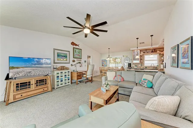 a living room with furniture and a ceiling fan