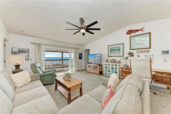 a living room with furniture large window and flat screen tv