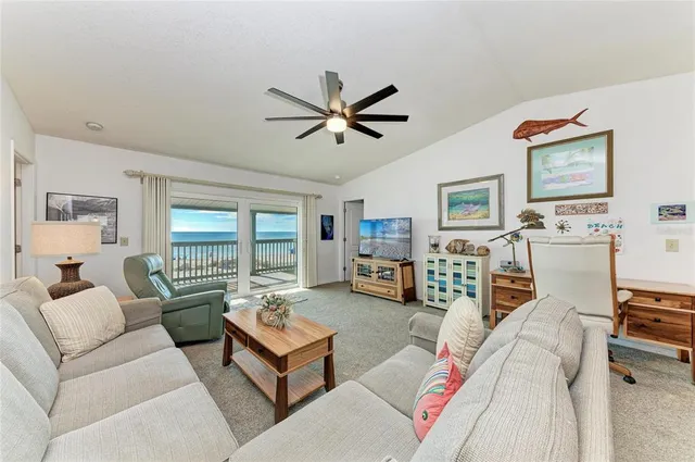 a living room with furniture and painting on the wall