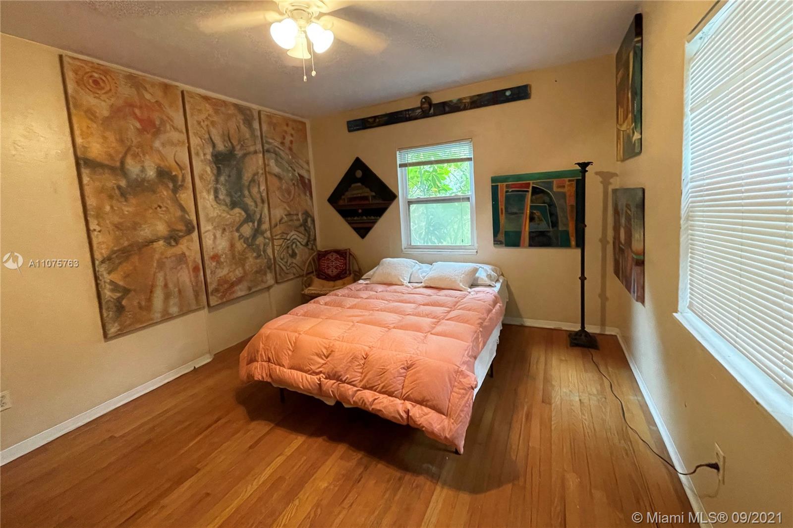 435 Northeast 77th Street Road Miami, FL 33138 - Photo 12 of 14 a bed sitting in a bedroom next to a window