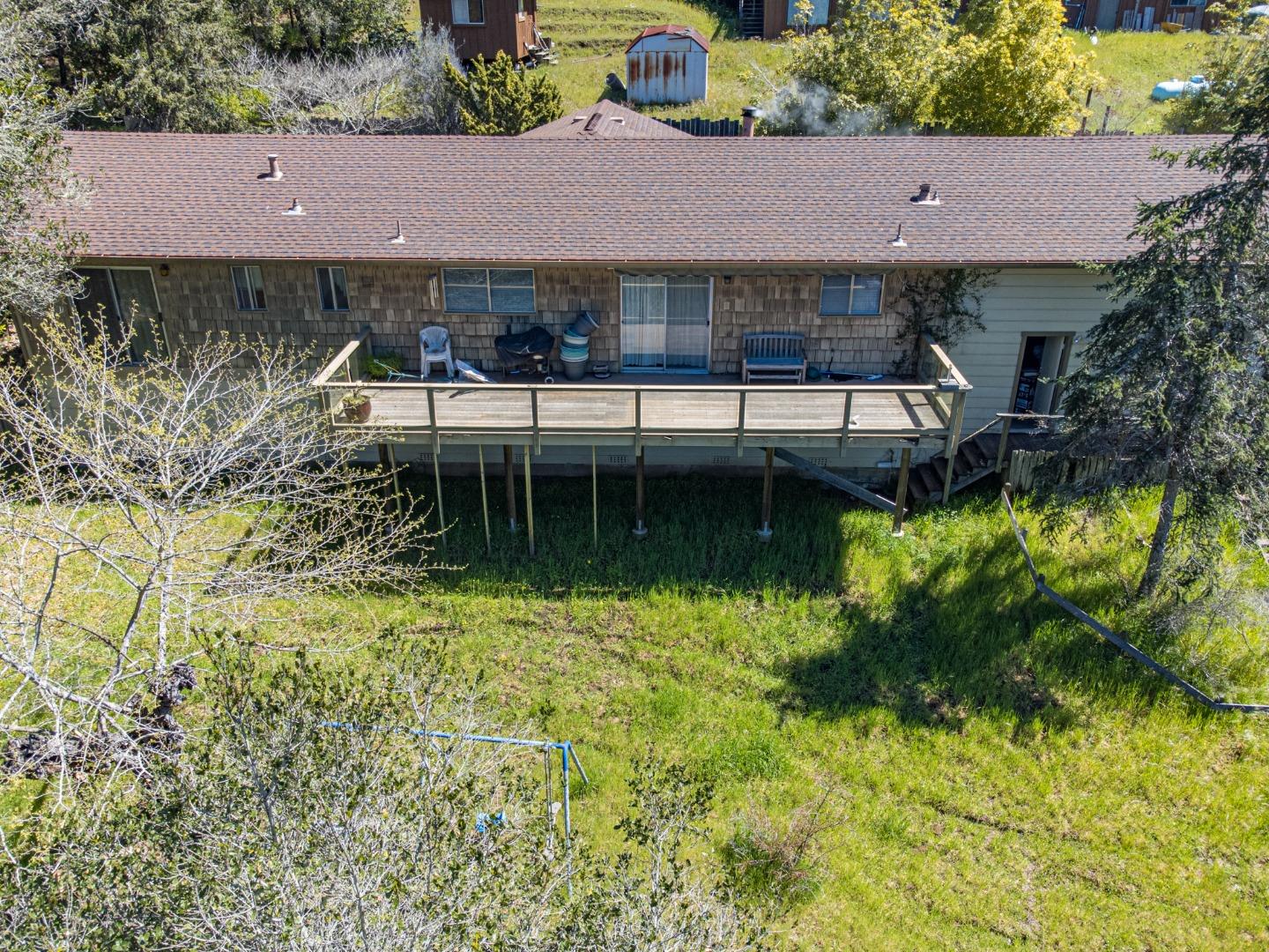 135 McKay Road Aptos, CA 95003 - Photo 42 of 57 a aerial view of a house with a yard table and chairs