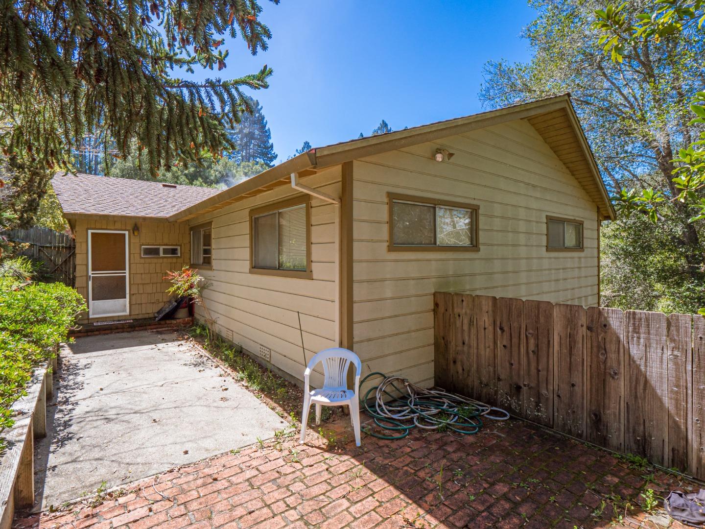 135 McKay Road Aptos, CA 95003 - Photo 47 of 57 a backyard of a house with chairs and table