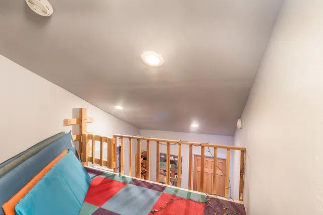 a bed sitting in a bedroom next to a window