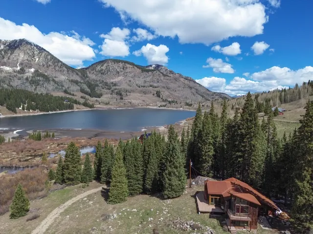 a view of a house with yard and sitting area